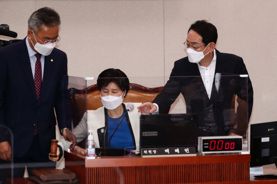 김도읍 국민의힘 간사(오른쪽)와 유상범 국민의힘 의원이 20일 국회에서 열린 법제사법위원회 전체회의에서 윤호중 법사위원장으로부터 사회권을 위임받은 백혜련 민주당 간사(가운데)가 회의를 진행하자항의하고 있다. 연합뉴스